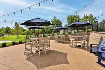 A patio with tables and chairs and umbrellas